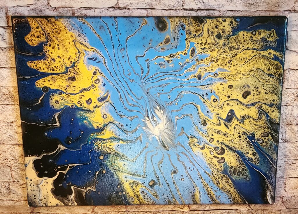 Abstract blue, gold, black, and white fluid painting.