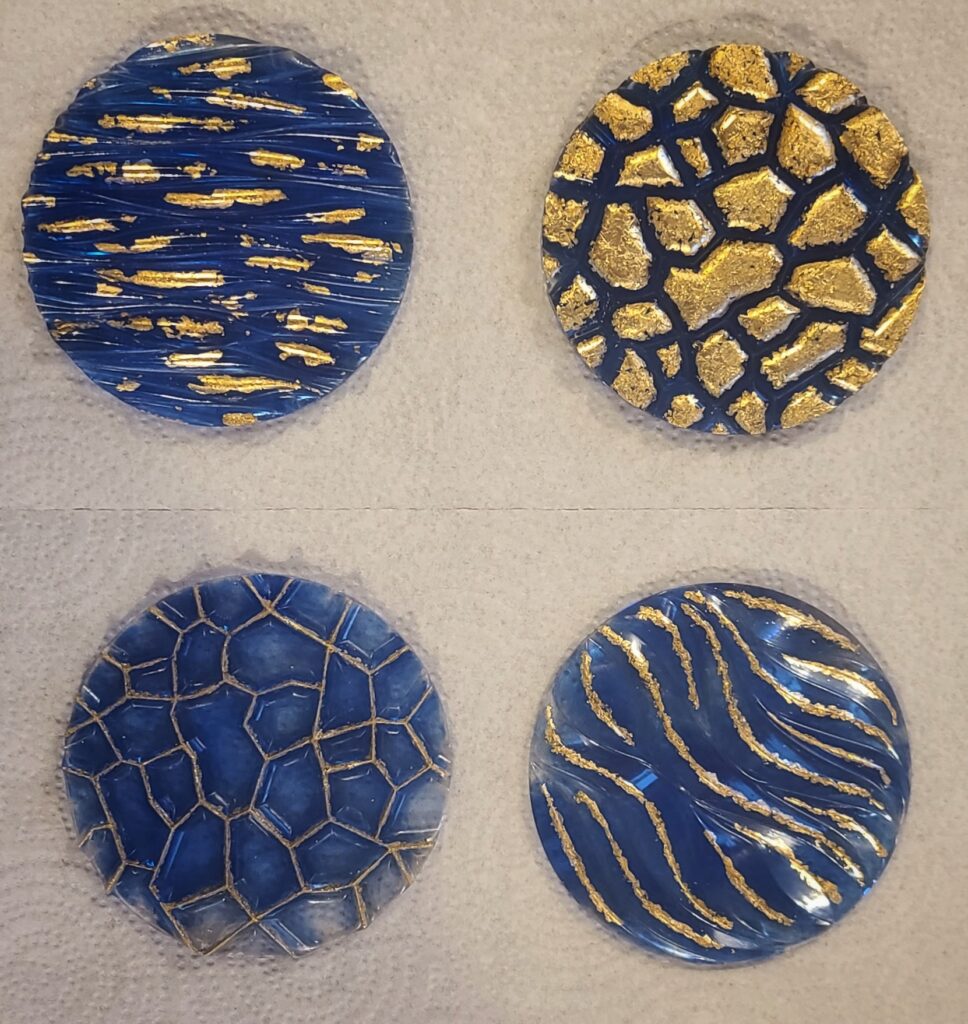 Blue and gold set of four coasters.