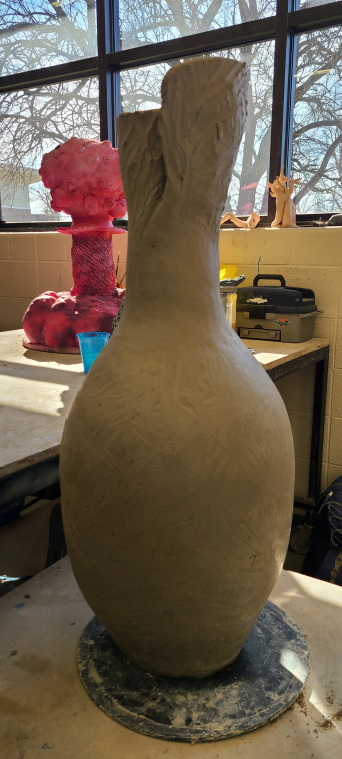 Pulling the pot top closer to closing.