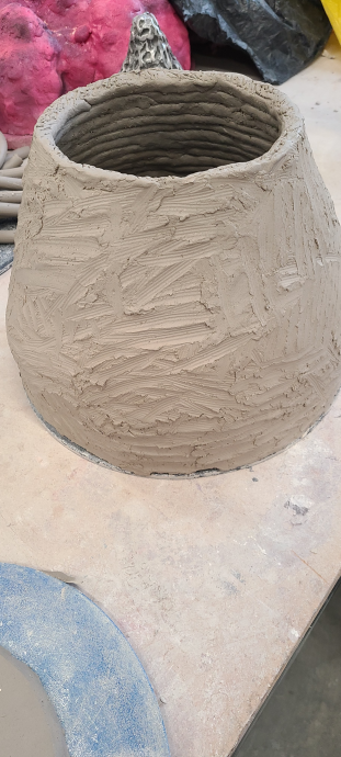 Smoothed clay pot base.
