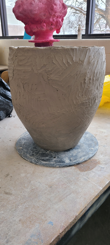 The clay pot flipped to work on the middle.